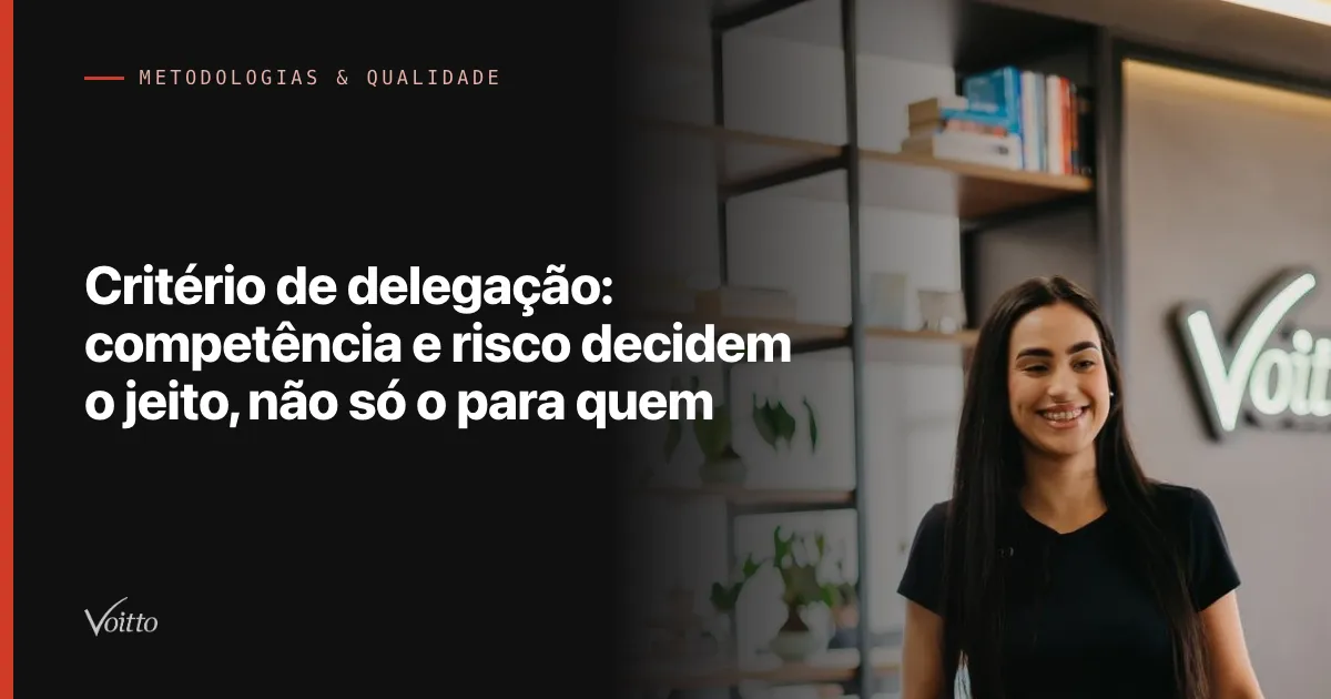 Colaboradora da Voitto de camiseta preta, sorrindo em pé no corredor do escritório com o letreiro desfocado ao fundo, com o texto Critério de delegação: competência e risco decidem o jeito, não só o para quem sobre fundo escuro à esquerda